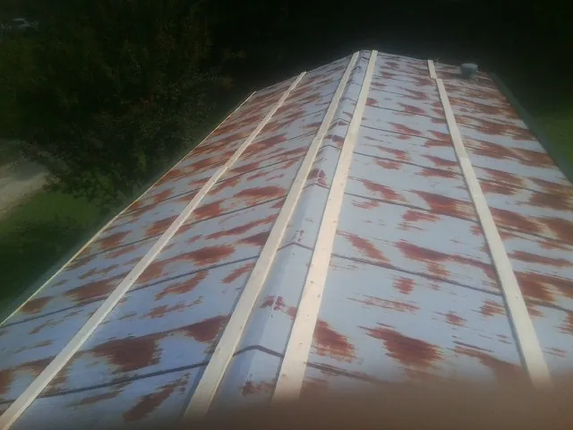 Rusted metal roof panels with new wood purlins before replacement — Storm Damage Roof Repair in Malabar by Roofing Brothers